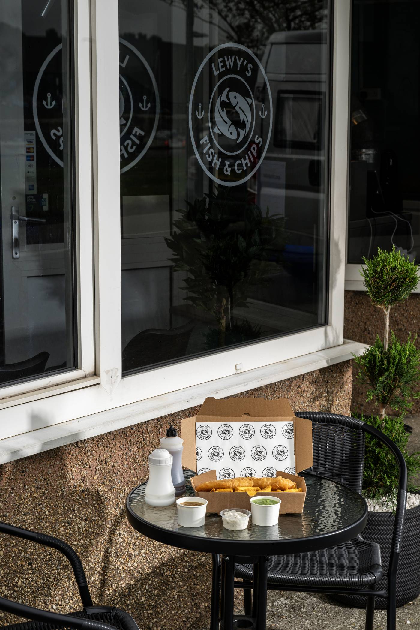 A Lewy's takeaway box on the outdoor table