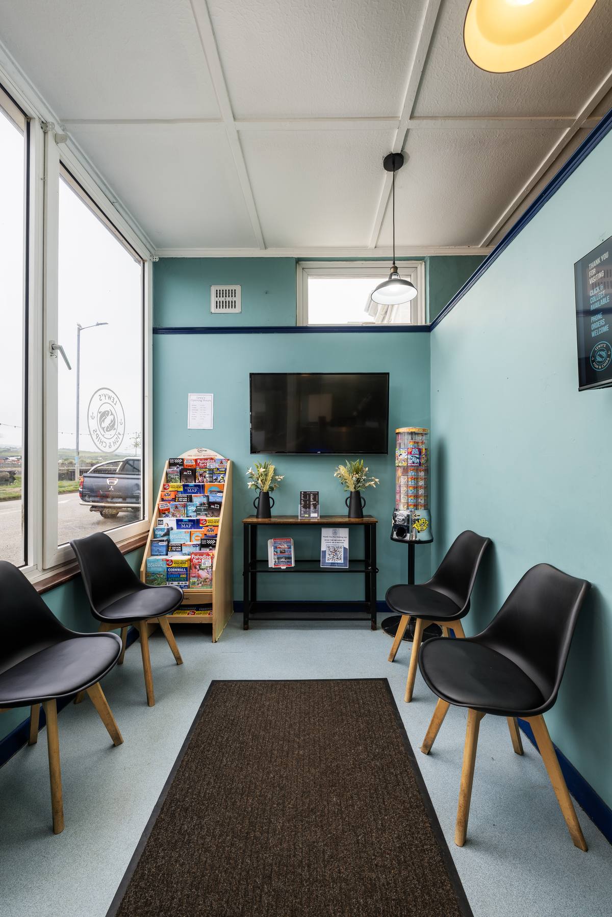 Inside Lewy's Fish & Chips in Hayle, Cornwall — window seating with view of the harbour